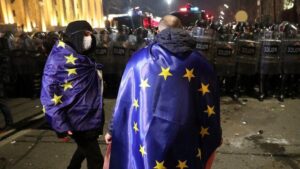 Read more about the article Police officers chasing a man out of Parliament